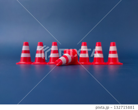 The image shows several miniature traffic cones, with one lying on its side. The image shows several miniature traffic cones, with one lying on its side. 132715881