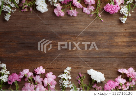 Spring Flowers Create a Colorful Border on a Rustic Wooden Table 132716120