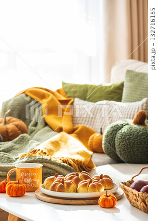 Autumn Table Setting with Pumpkin-Shaped buns with Cinnamon, Apples, Pumpkins, and Cozy Decor 132716185