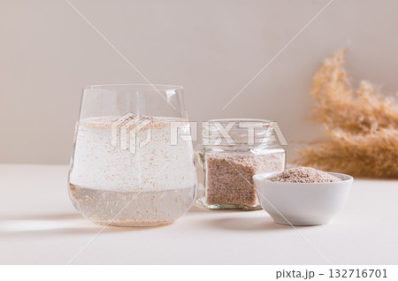 A glass of water and psyllium husk on the table for health 132716701