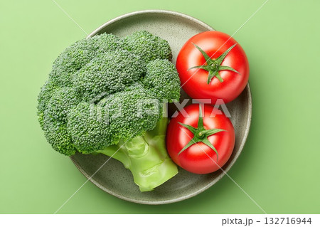 Broccoli and Tomatoes on Plate (Green Background) 132716944
