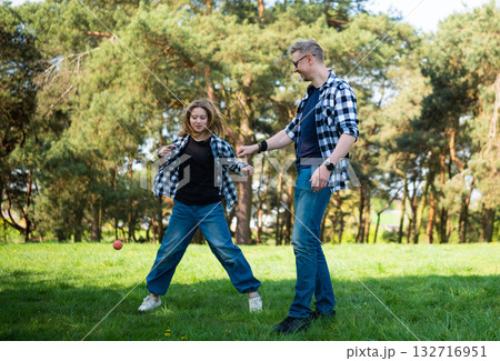 Father And Daughter Spend Time Practicing Play With An Elastic Ball Toy In The Summer Park 132716951