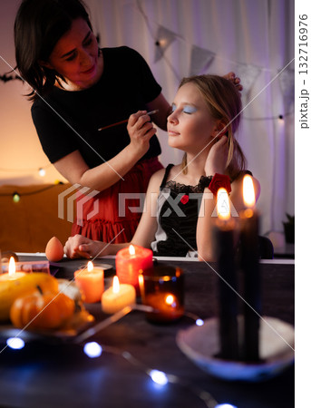 Mom Doing Spooky Halloween Makeup For Daughter And Preparing Costume Mom Doing Spooky Halloween Makeup For Daughter And Preparing Costume 132716976