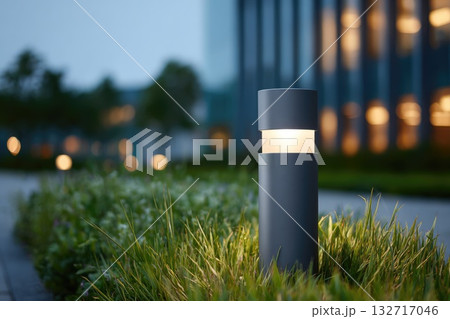 Modern bollard garden light illuminating walkway at night 132717046