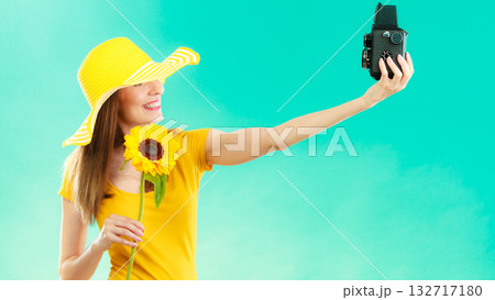 Summer woman holds sunflower old camera Summer woman holds sunflower old camera 132717180