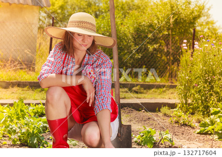 woman with gardening tool working in garden woman with gardening tool working in garden 132717604