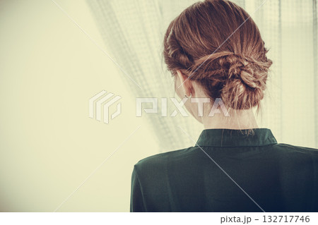 Alone woman looking through window waiting 132717746