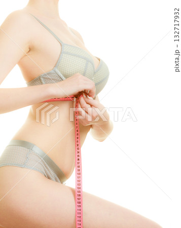 Woman in bra lingerie measuring her chest breasts. Woman in bra lingerie measuring her chest breasts. 132717932