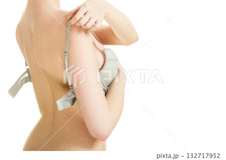 Attractive slim woman taking off grey bra 132717952