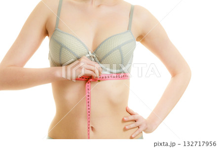 Woman in bra lingerie measuring her chest breasts. Woman in bra lingerie measuring her chest breasts. 132717956