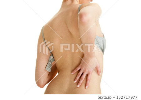 Attractive slim woman taking off grey bra 132717977