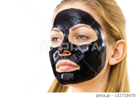 Woman with black peel off mask on face 132718078
