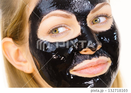 Woman with black peel off mask on face Woman with black peel off mask on face 132718103