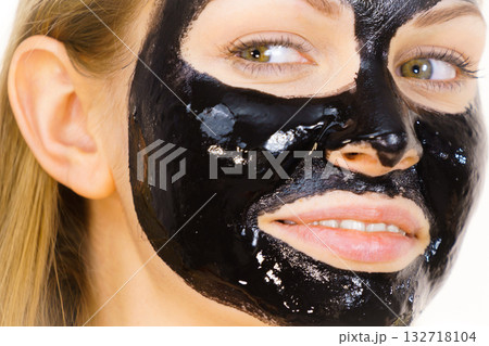 Woman with black peel off mask on face Woman with black peel off mask on face 132718104