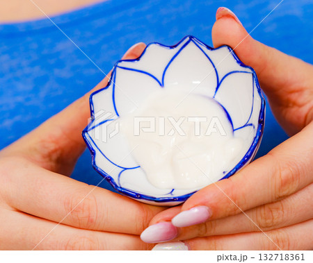 Girl holds bowl with cream cosmetic 132718361
