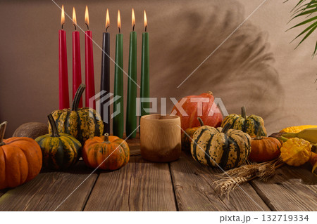 Kwanzaa. African holiday Kwanzaa with decoration of seven candles and pumpkins Kwanzaa. African holiday Kwanzaa with decoration of seven candles and pumpkins 132719334