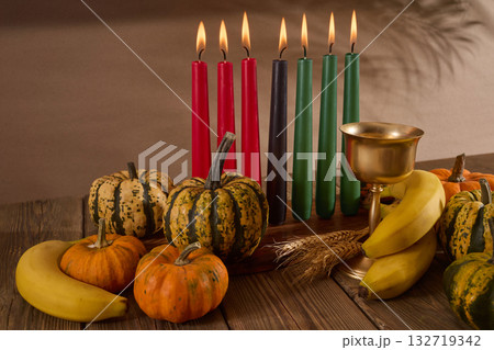 Kwanzaa. African holiday Kwanzaa with decoration of seven candles and pumpkins 132719342