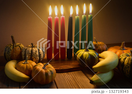 Kwanzaa. African holiday Kwanzaa with decoration of seven candles and pumpkins Kwanzaa. African holiday Kwanzaa with decoration of seven candles and pumpkins 132719343