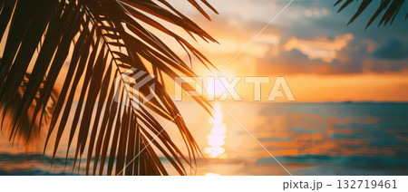 Tropical sunset view through palm leaves on beach Tropical sunset view through palm leaves on beach 132719461