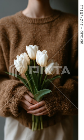 Woman Holding a Bouquet of White Tulips While Wearing a Cozy Brown Sweater Indoors 132720111