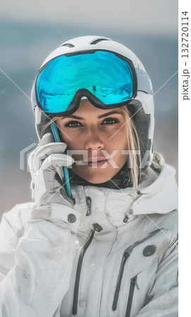 Winter Sports Enthusiast Makes a Phone Call While Skiing in the Mountains During Daylight 132720114