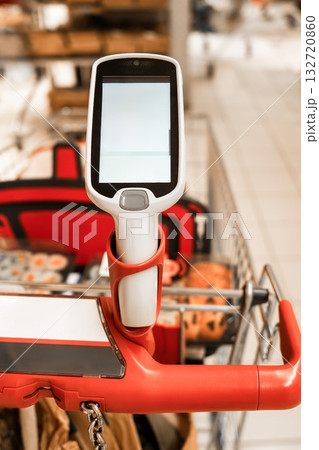 A hand-held scanner on a shopping cart in a supermarket 132720860
