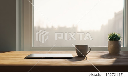 Laptop And Coffee Mug On Wooden Desk By Window With Potted Plant. Minimalist Workspace With Natural Light 132721374