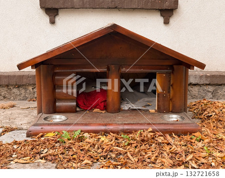 Wooden dog house under autumn trees. Compassion, care, and warmth through small shelter design 132721658