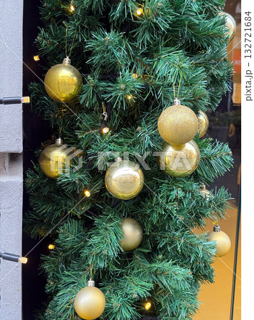 Christmas golden ornaments and lights. Celebration, holiday spirit, and festive decoration bringing warmth and seasonal joy. 132721684