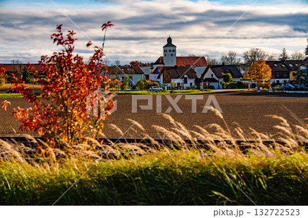 Church In Gilching, Bavaria: Picturesque Autumn Village Landscape With Colorful Trees, Golden Fields, And Dramatic Sky Near Munich 132722523
