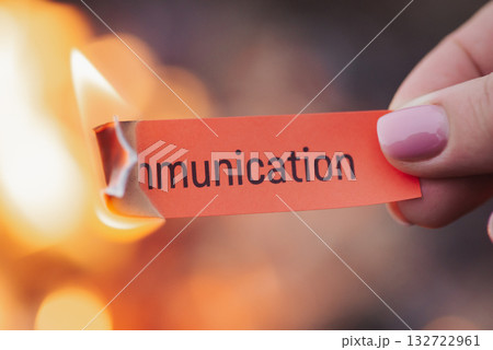 Close up of small red paper in female hand outdoors with burning word Communication. Finished relations, divorce, broken heart, starting new life Close up of small red paper in female hand outdoors with burning word Communication. Finished relations, divorce, broken heart, starting new life 132722961
