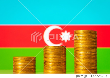 Three stacks of coins in front of Azerbaijan flag. Development of Azerbaijan concept 132723223