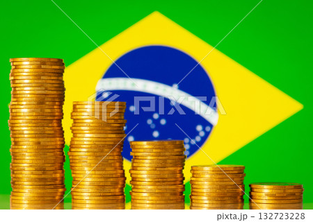 Stacks of coins forming negative graph against flag of Brazil. Concept of economic regression, crisis in country Stacks of coins forming negative graph against flag of Brazil. Concept of economic regression, crisis in country 132723228
