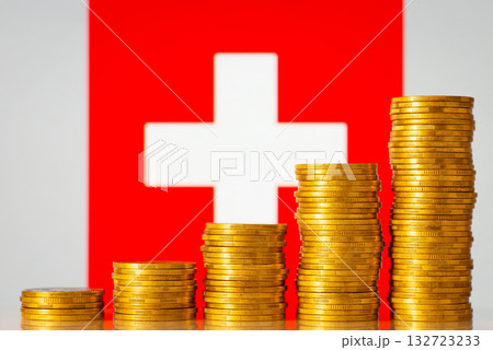 Upgoing graph made of coins stacked in front of Swiss flag. Concept of quick financial development of Switzerland 132723233