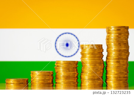 Stacks of golden coins forming uprising graph in front of India flag. Concept of development of Indian financial system Stacks of golden coins forming uprising graph in front of India flag. Concept of development of Indian financial system 132723235
