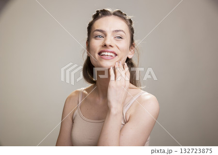 Portrait of feminine skincare model with a candid smile and smooth skin, looking happy and empowered in a beauty advertisement with natural makeup. Showcasing authenticity and self love. Portrait of feminine skincare model with a candid smile and smooth skin, looking happy and empowered in a beauty advertisement with natural makeup. Showcasing authenticity and self love. 132723875