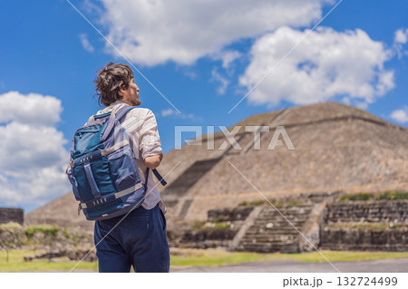 Male tourist posing in front of the pyramids of Teotihuacan in Mexico, enjoying sightseeing, cultural heritage, and travel adventure Male tourist posing in front of the pyramids of Teotihuacan in Mexico, enjoying sightseeing, cultural heritage, and travel adventure 132724499