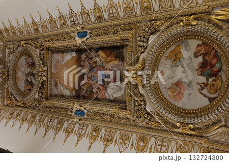 Gilded ceiling panel with roundel and framed paintings pearls and floral reliefs intricate renaissance decoration Vatican Museums close up. High quality photo 132724800