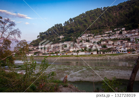 Sunset over the town of Berat on the Osum River, known for its white Ottoman houses. Also called the 'City of a Thousand Windows,' it is built against the hillside below the citadel. Sunset over the town of Berat on the Osum River, known for its white Ottoman houses. Also called the 'City of a Thousand Windows,' it is built against the hillside below the citadel. 132728019