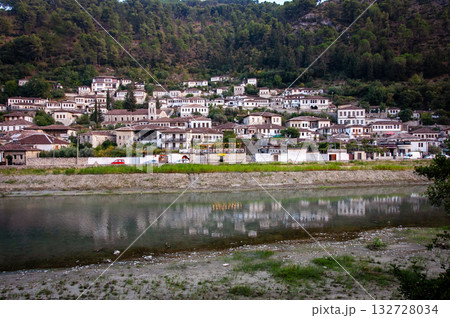 Sunset over the town of Berat on the Osum River, known for its white Ottoman houses. Also called the 'City of a Thousand Windows,' it is built against the hillside below the citadel. Sunset over the town of Berat on the Osum River, known for its white Ottoman houses. Also called the 'City of a Thousand Windows,' it is built against the hillside below the citadel. 132728034