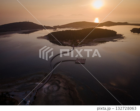 Aerial landscape photography. Fantastic morning view of St Mary's Monastery and wooden pier. Magnificent spring seascape of Narta Lagoon. Beautiful outdoor scene of Albania, Europe. Aerial landscape photography. Fantastic morning view of St Mary's Monastery and wooden pier. Magnificent spring seascape of Narta Lagoon. Beautiful outdoor scene of Albania, Europe. 132728063