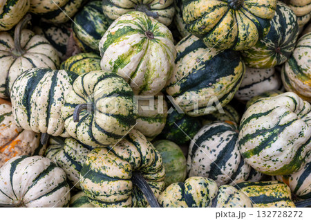 Close-up pile of pumpkins Fresh orange pumpkins stacked tightly, perfect seasonal harvest background for autumn and Halloween. 132728272