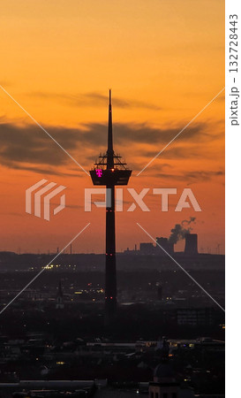 A breathtaking view of the Cologne skyline during sunset featuring the iconic Cologne Cathedral and the city's famous bridge. The warm hues of the evening sky create a stunning scene in Germany. A breathtaking view of the Cologne skyline during sunset featuring the iconic Cologne Cathedral and the city's famous bridge. The warm hues of the evening sky create a stunning scene in Germany. 132728443