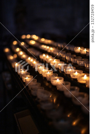 A serene scene of glowing candles inside Cologne Cathedral, Germany. 132728459