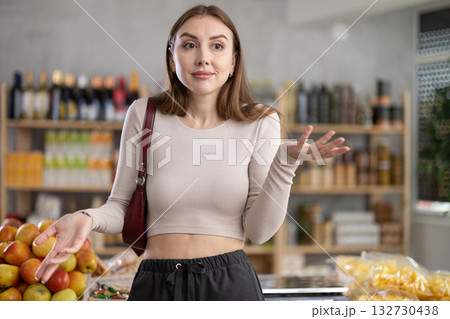 Female shopper has difficulty remembering what to buy at grocery supermarket 132730438