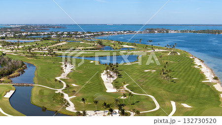 Aerial view of large golf field with green grass in Boca Grande, small town on Gasparilla Island in southwest Florida. Outdoor activities for wealthy people Aerial view of large golf field with green grass in Boca Grande, small town on Gasparilla Island in southwest Florida. Outdoor activities for wealthy people 132730520