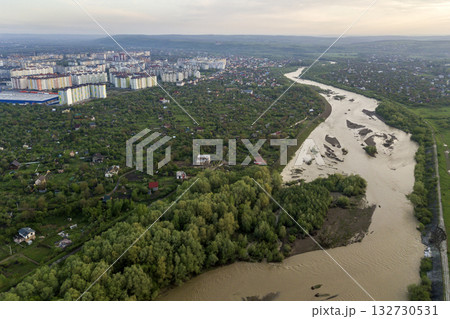 Aerial view of Ivano-Frankivsk city with residential area and suburb houses with a river in middle. Aerial view of Ivano-Frankivsk city with residential area and suburb houses with a river in middle. 132730531
