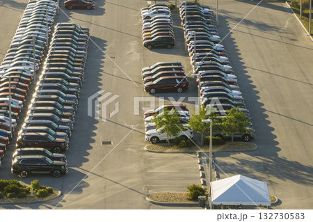 Aerial view of dealership parking lot with many brand new cars for sale. Development of american automotive industry concept Aerial view of dealership parking lot with many brand new cars for sale. Development of american automotive industry concept 132730583