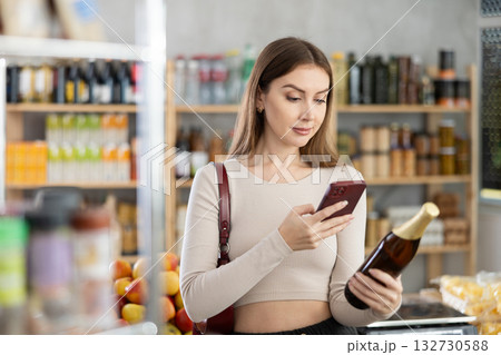 Young woman scanning qr code of beer Young woman scanning qr code of beer 132730588