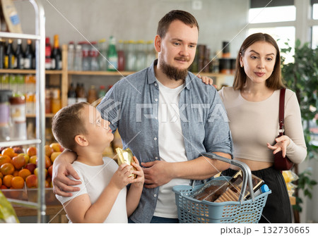 Man with wife and son shopping in grocery store 132730665